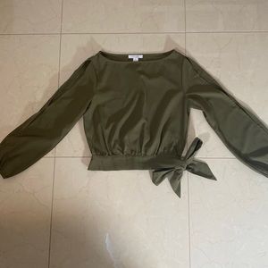 Cute slightly cropped peek-a-boo sleeve top. Tie waist detail.